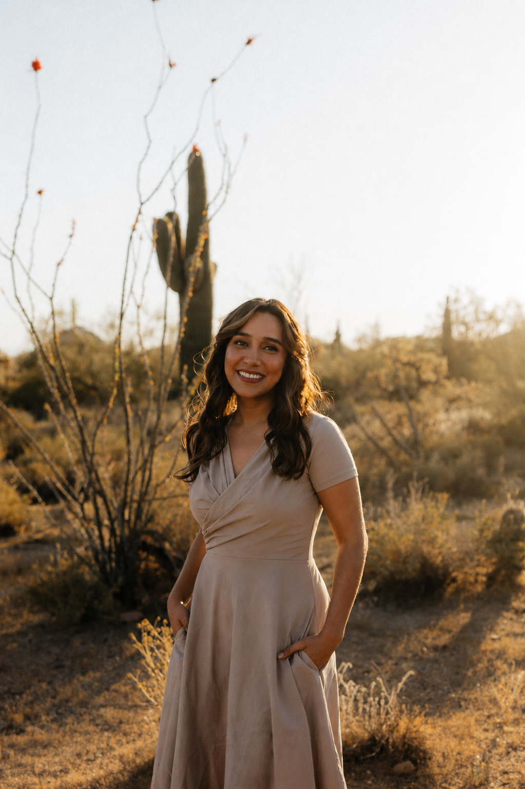 Paola Villa, LCSW, smiling in a golden-hour Sonoran desert landscape